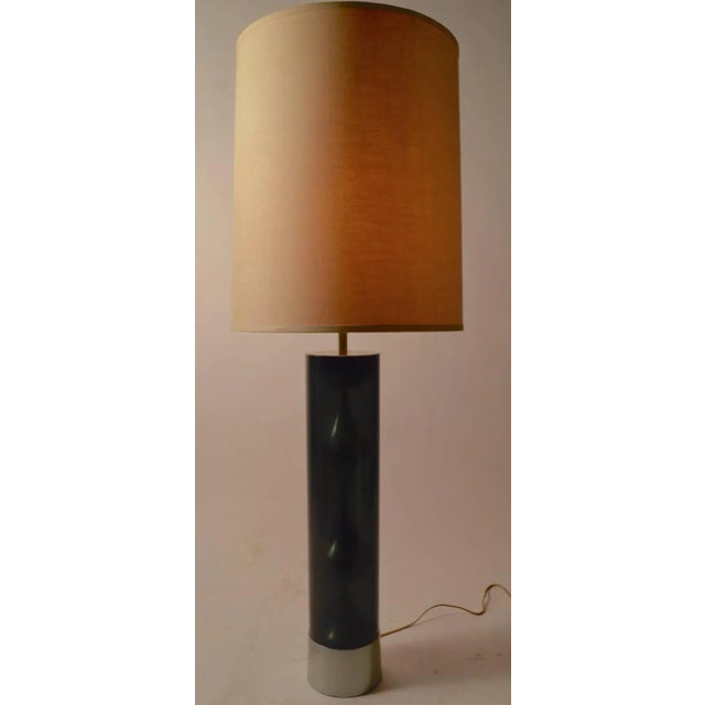 This table lamp features a dark smoked Lucite tube which houses a decorative chrome element. The lamp included the...