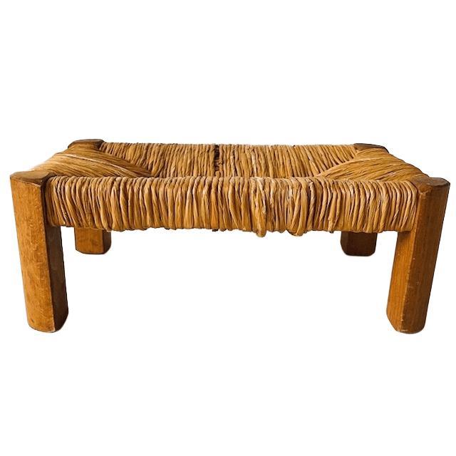 Nice vintage mid-century wicker footstool with a rattan seat and teak legs from the 1960s. The vintage rattan stool is in...