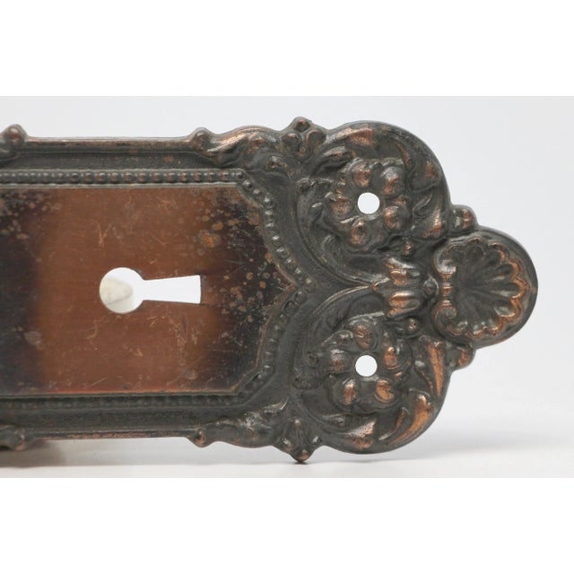 Neoclassical japanned finished cast iron passage door back plates with keyhole. Made by Yale & Towne in 1905. It is part...