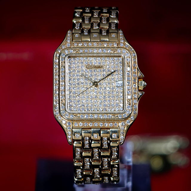 This Cartier Panthere reference 8839 Jumbo features a full pave diamond-set dial, bezel, and case in 18K yellow gold, with...