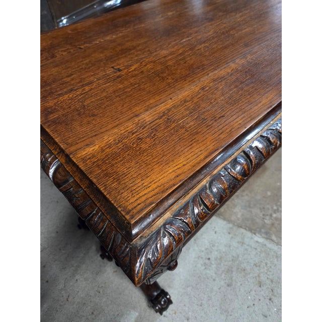 This English Antique Oak Heavily Carved Late 19th Century Desk With Barley Twist Legs would definitely make a statment in...