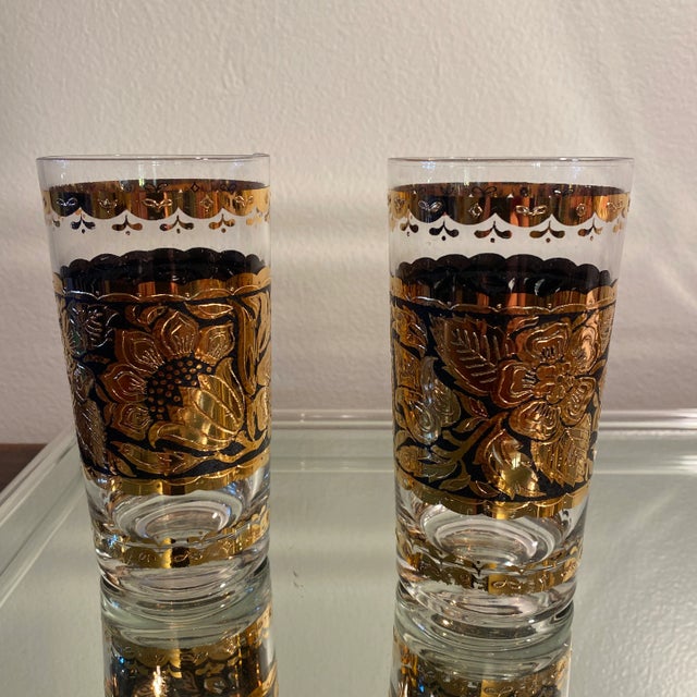 This gorgeous set of 4 mid century vintage collins glasses were designed by Georges Briard with a 22k gold floral pattern...