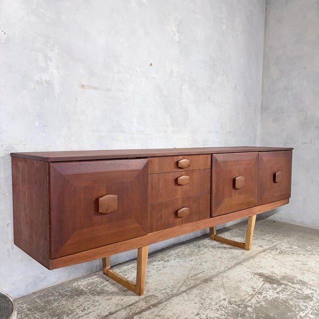 An exceptional mid century teak long sideboard by Stonehill Furniture , combining bold British design with superb...