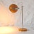 Mid-Century Modern lamp consisting of a circular base with switch and a spherical spotlight made of lacquered metal in...