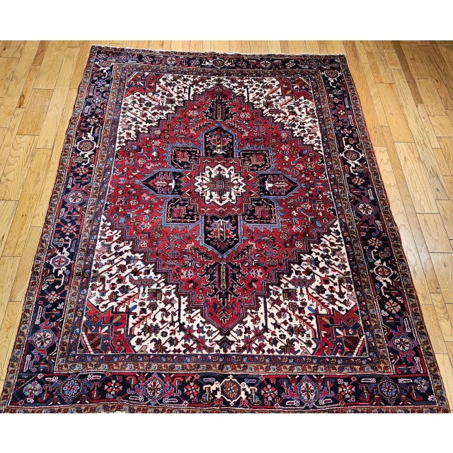 "This vintage Persian Heriz rug from the second quarter of the 20th century features a rich red field as the vibrant...