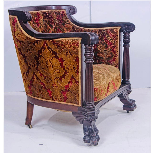 A richly detailed Jacobean Revival armchair, dating to the early 20th century, combining bold carved oak construction with...