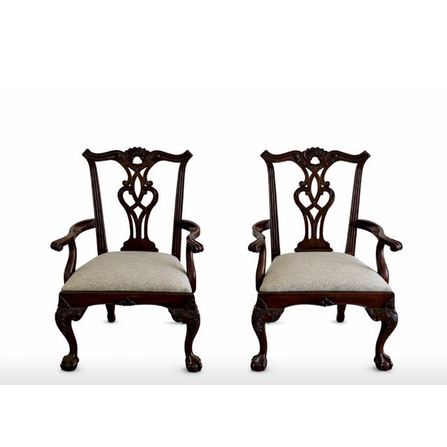 The set includes two armchairs and eight side chairs, all crafted in carved mahogany, elegant pierced splat backs and...