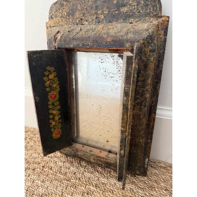 Antique Persian wall mirror. Carved wood with Handpainted doors that open to an Antiqued mirror inside. From the 1900's....