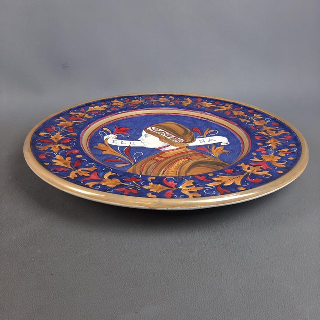 Stunning blue luster majolica plate with gold and ruby ​​reflections, with a depiction of Elena hand painted by the well-...
