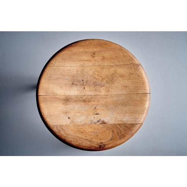 This rustic three-legged stool is crafted from solid oak, and has a beautifully worn, sculptural presence. The thick,...