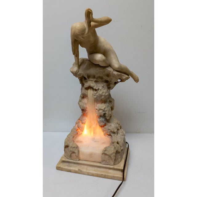 We are offering this stunning early 20th century Alabaster Lamp. This lamp has great form of a nude figure atop a...