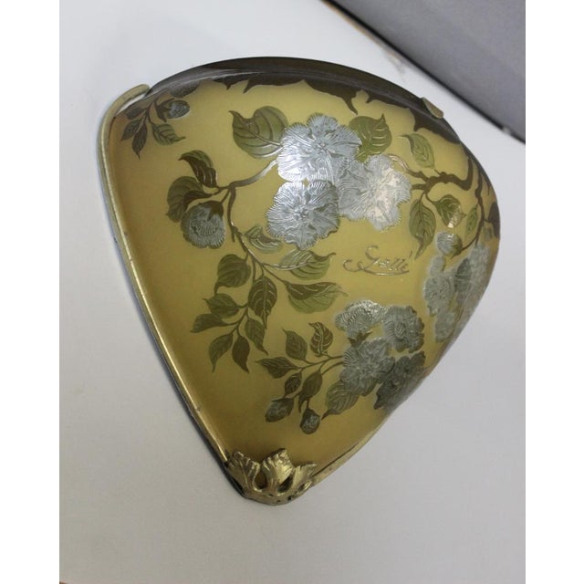 Pair of wall lights signed Gallé Tip, flower and leaf decoration, bronze mount, yellow, blue and green color, acid work,...