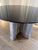 Elegant Vanguard Stafford Dining Table This is a sophisticated round dining table featuring a sleek black glass top paired...