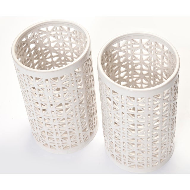 Oversized reticulated ceramic candle-holder in white. Suitable for both outdoors or indoor use. The candlelight projects a...