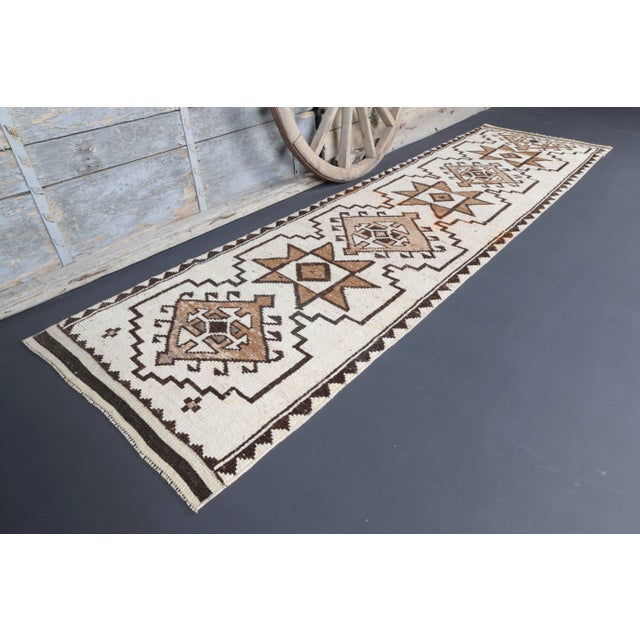 Vintage Turkish Hand-Knotted vintage rug is a semi-Vintage runner rug.'70s Eastern region of Turkey's unique rug is...