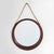 A 1960s oval wall mirror, distinguished by its understated design, combining the softness of the wooden frame with the...