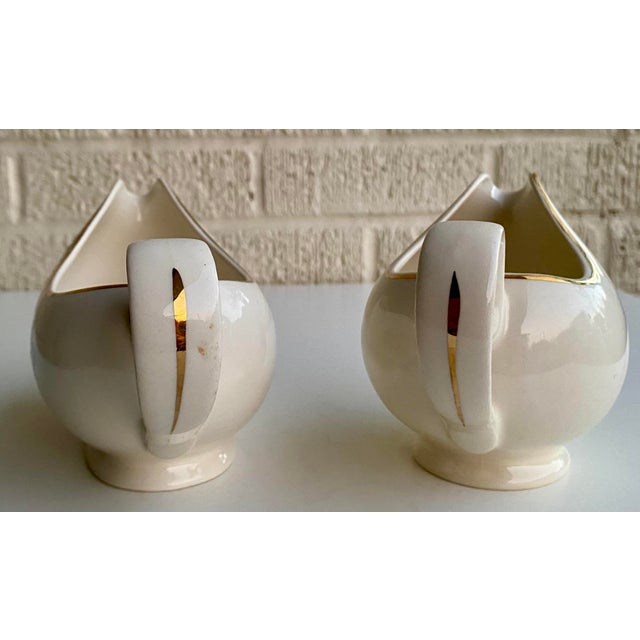 Charming set of 2 vintage porcelain gravy boats featuring soft pink roses, leafy green stems, and elegant gold rim...