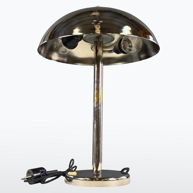 This elegant 1930s chrome table lamp embodies the refined simplicity of Czech Functionalism. The lamp’s polished metal...