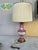 This vintage lamp is pink and decorated with floral and amorous scenes with Victorian ladies of the court, and are set on...