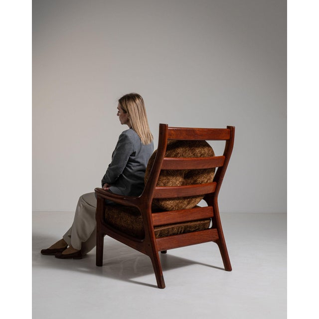 This piece presents as a armchair, distinguished by dark wood frame, cognac/tan leather upholstery. It was made in France...