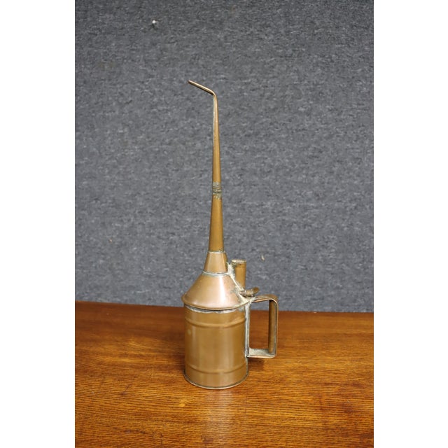 Antique industrial oil can manufactured by The Ludlow Manufacturing Company, marked on the side with its maker’s name and...