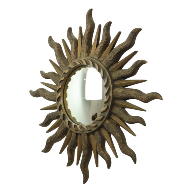 Vintage dark gold sunburst mirror—also known as a "butler's mirror" or "witch's mirror"—featuring a convex glass surface...
