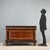 Mid-20th century Italian chest of drawers, crafted in walnut and walnut burl with ebonized details. The green serpentine...