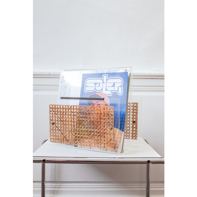 A stunning 1970s magazine rack crafted from curved acrylic glass. Its monolithic construction lends it a remarkably pure...