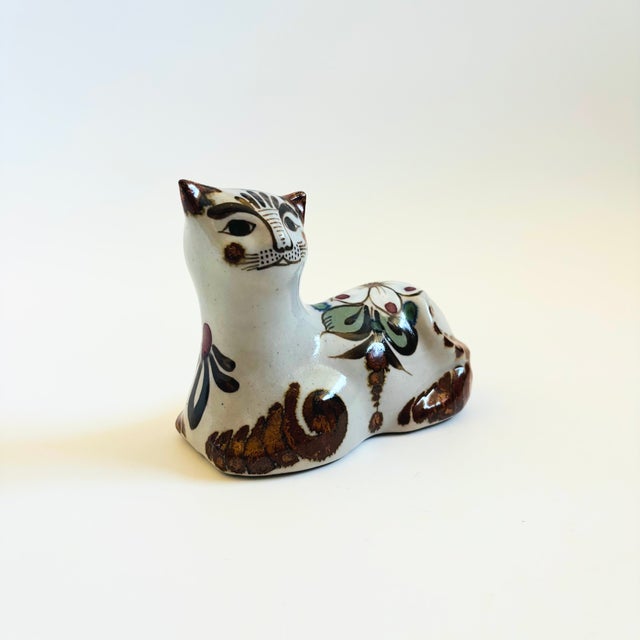 A handmade vintage pottery cat. Pale gray glaze with beautiful hand painted designs in brown, green, and white with some...