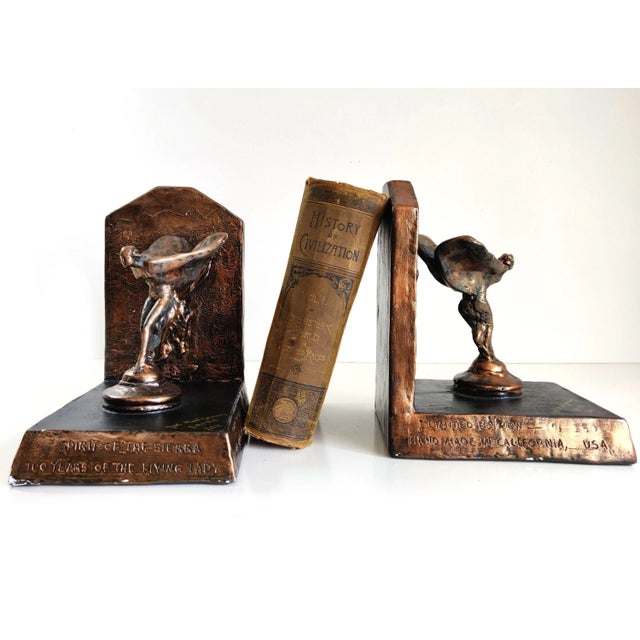 Large Ceramic Flying Lady Bookends A pair of ceramic or plaster bookends, each with a Rolls Royce flying lady emblem...