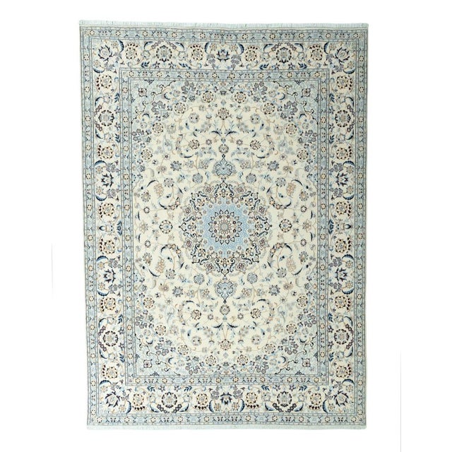 This exquisite Nain 9La rug impresses with its particularly fine knotting, harmonious color scheme, and delicate silk...