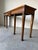 This elegant vintage Neoclassical style console table is beautifully crafted from solid mahogany and features exquisite...