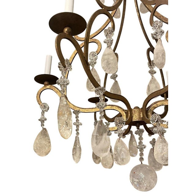 An elegant Italian mid-20th-century chandelier handcrafted in wrought iron and richly adorned with hand-cut rock crystal...
