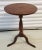 Circa 1820, American walnut candle stand or small round table featuring a turned column base raised on three cabriole legs...