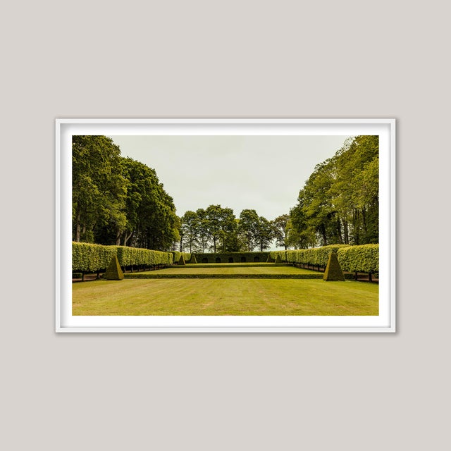 Le Jardin, Brittany, France—a serene and painterly photograph capturing the elegance of a private château’s garden. Softly...