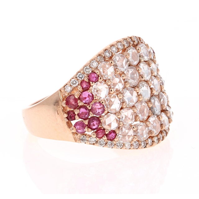 This ring has Natural Rose Cut Diamonds that weigh 1.41 Carats and has 23 Round Cut Rubies that weigh 0.80 Carats. It is...