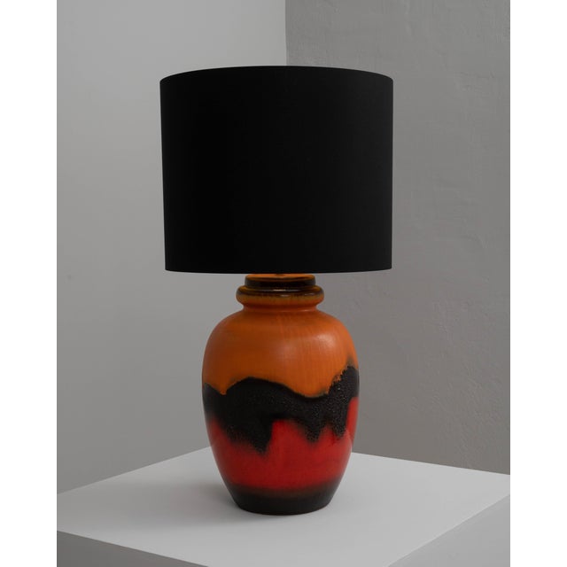Add a bold statement to your interior with this striking 20th-century German ceramic table lamp. The vivid, fiery red base...