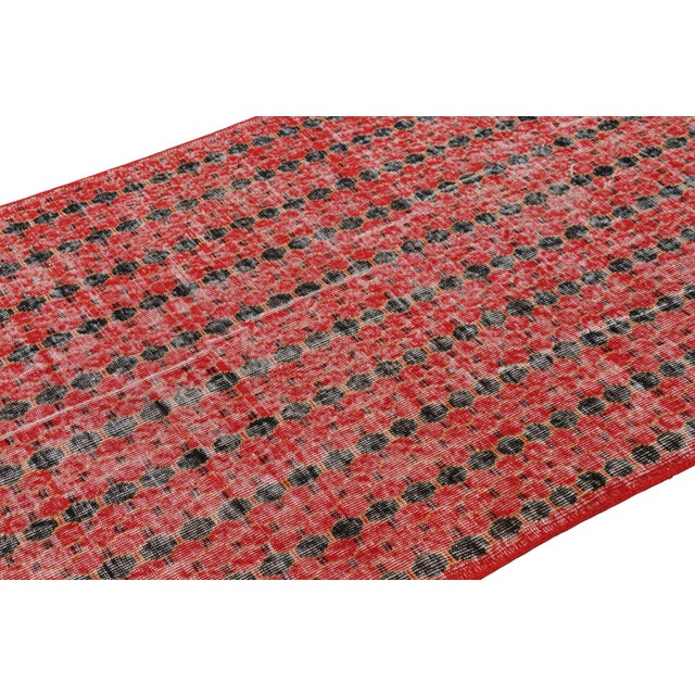 Made with hand-knotted wool circa 1960-1970, this 4x6 vintage rug from Turkey is believed to be the work of mid-century...