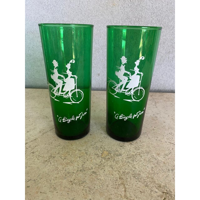Mid-century emerald green glass tumblers with white designs. Made by Anchor Hocking Glass Company 2 of one design 6 of...