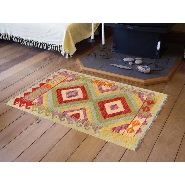 Elevate the elegance of your home with this stunning hand-woven tribal Kilim wool rug. Meticulously crafted on a loom by...