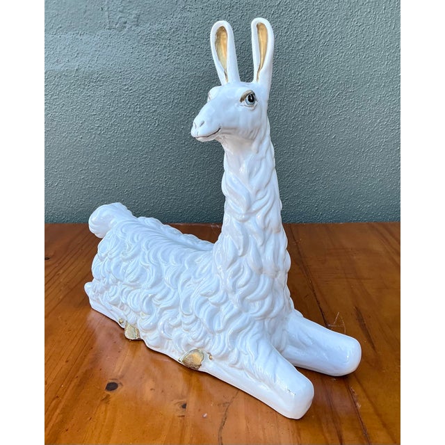 This charming vintage llama sculpture is a quintessential example of Hollywood Regency whimsy and sophisticated animalier...