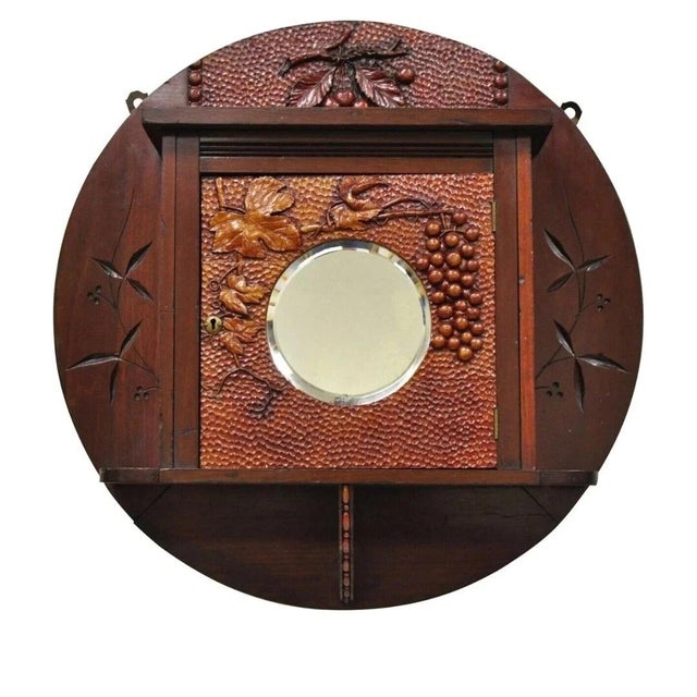 Antique Victorian Black Forest Carved Round Wall Mirror Curio Cabinet. Item features a round beveled glass central mirror,...