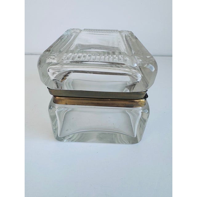 A 19th century glass crystal and brass jewelry box from France. It has a handsome linear cut pattern along the borders....