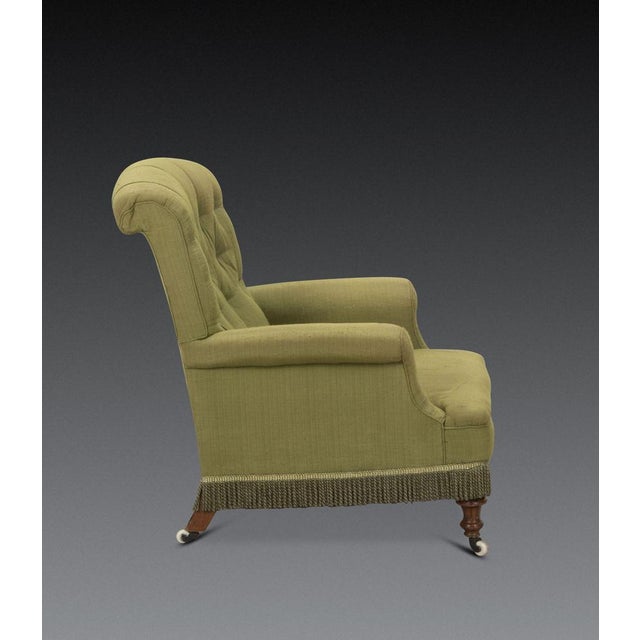 A comfortable 19th century english easy armchair. neatly upholstered in brushed sage green linen fabric, with a buttoned...