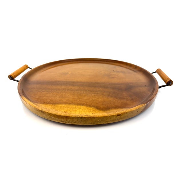 This vintage round wooden serving tray features beautiful natural grain and warm tonal variation that highlights the...