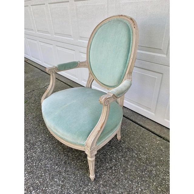 A stunning French Provincial Louis XVI fauteuil style armchair France, Circa 1920s Carved painted wood frame, with light...