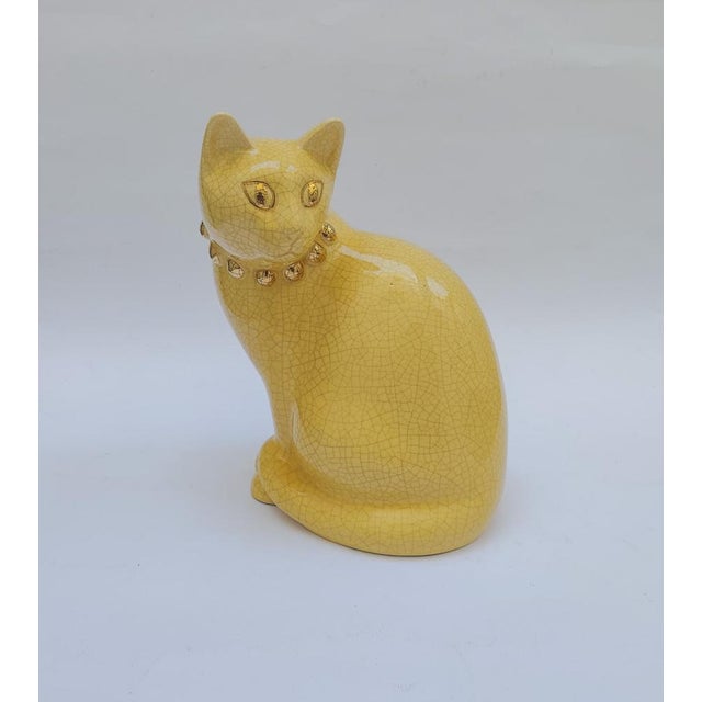 Yellow ceramic cat with faux crackle detail and cabochon necklace Decorated with gold necklace and eyes Marked under the...