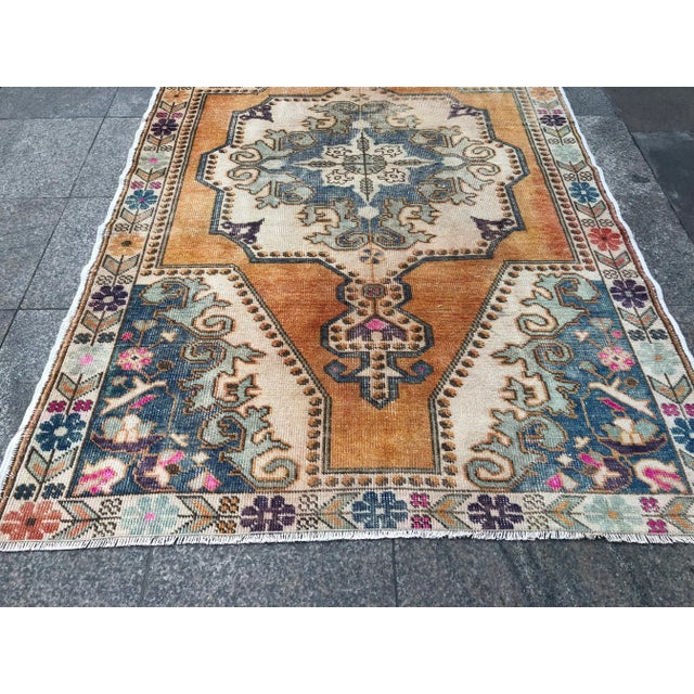 This is a vintage Turkish Oushak rug from the 1960s. The piece was hand-knotted.