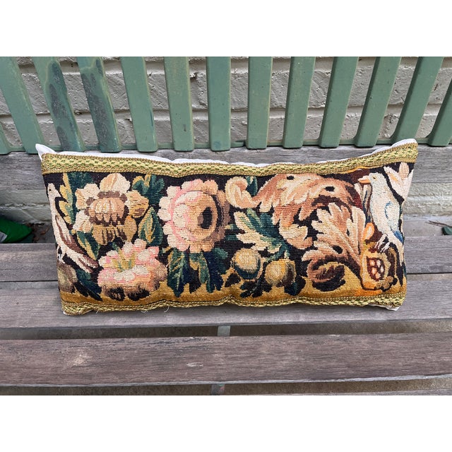 A beautiful pillow upholstered in 18th-century tapestry, featuring charming birds depicted at each end. Rich in antique...