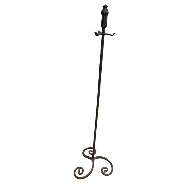 4 piece set of iron fireplace tools. Shovel, tongs and poker held on a three legged based. Poker is split near center and...